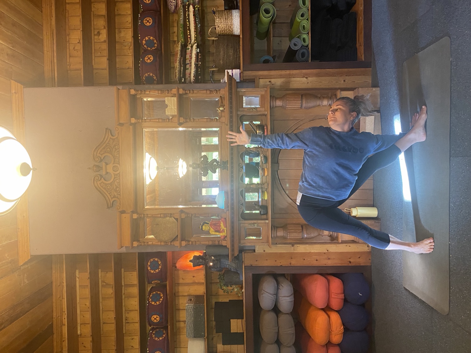 Grounded triangle pose in the warm timber b.YOGA studio