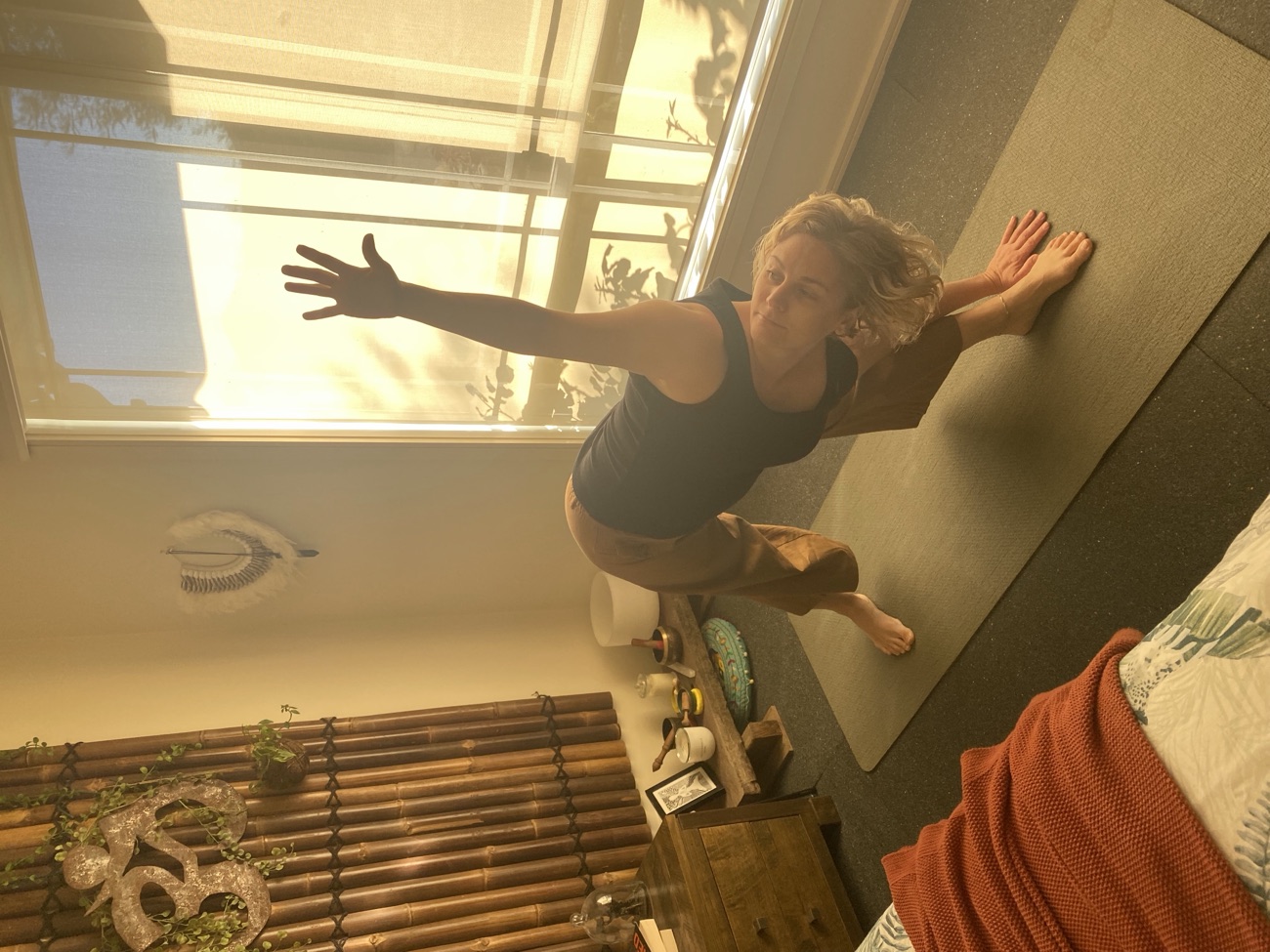 Revolved twisting pose with lifted arm in a home practice space